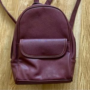 Vegan Mini Backpack with Adjustable Straps and Pockets in Burgundy.